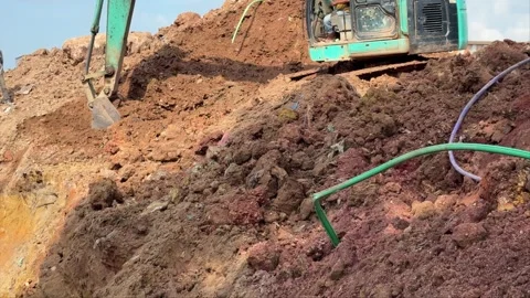 Dynamic Earthmoving Operations: Heavy Equipment Precisely Excavates Reddish.. Video stock 337286394