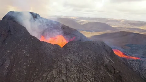 Dynamic eruption of molten lava and smoke from active volcano crater. Stock Footage 337762917