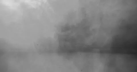 A dynamic explosion erupts amidst a swirling backdrop of smoke and dramatic Video stock 295051493