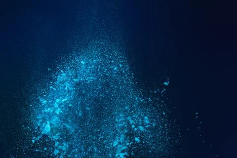 Dynamic Explosion of Vibrant Blue Powder Particles Scattering Against a Dar.. Stock Photos