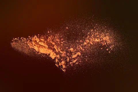 Dynamic Explosion of Vibrant Orange Powder Particles Scattering Against a D.. Stock Photos