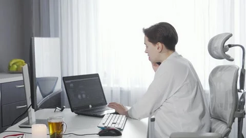Dynamic female entrepreneur multitasking on two computers while on a phone call Stock Footage 311918247