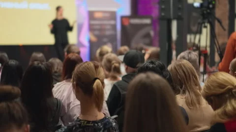 Dynamic female speaker gestures passionately during a tech innovation seminar Stock Footage 268870898