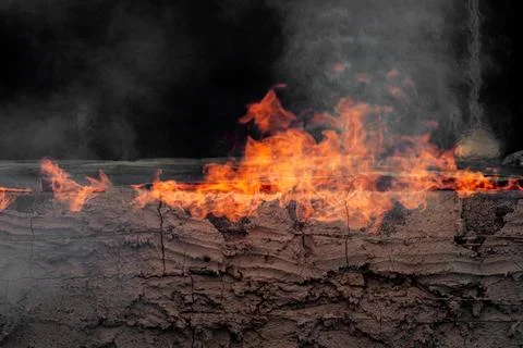 Dynamic fire flames burning with smoke creating an abstract background text.. Photos