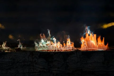 Dynamic fire flames burning with smoke creating an abstract background text.. 库存照片