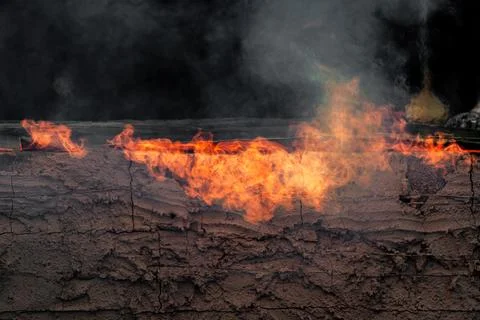 Dynamic fire flames burning with smoke creating an abstract background text.. Photos