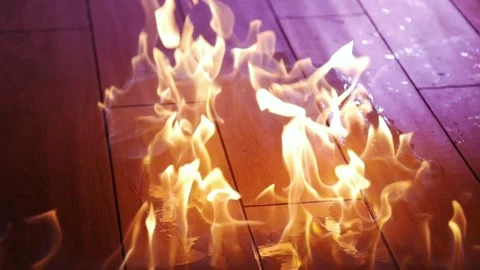Dynamic flames are flickering vibrantly over a beautiful wooden floor beneath Stock Footage 304264863