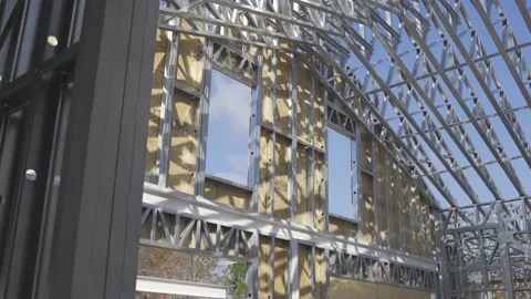 A dynamic footage of the steel frames of a house or unfinished structure. Stock Footage 220538128