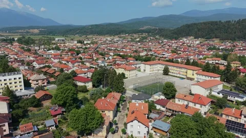 Dynamic forward drone push in over schoolyard in Razlog, Bulgaria Stock Footage 344057423