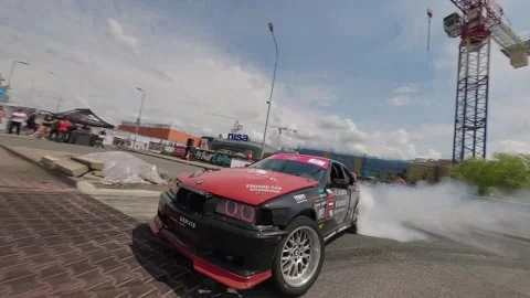 Dynamic FPV Chase of Black-Red BMW With Front View Moment Stock Footage 322972223