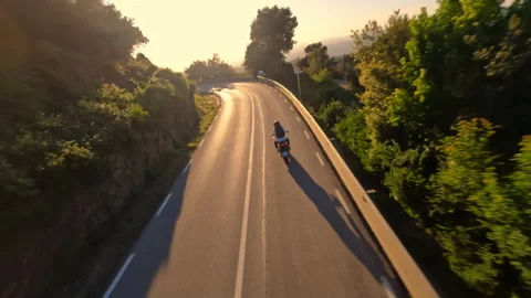 Dynamic fpv drone shot chasing Motorcycle driving under the bridge while sunset Vídeos de archivo 233192043