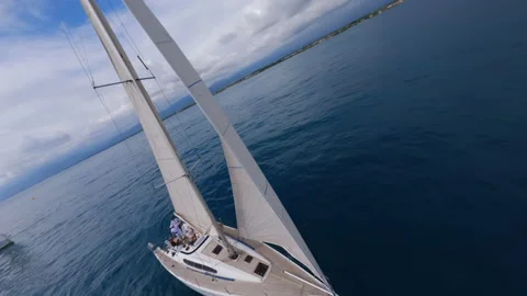 Dynamic Fpv drone shot of white yachts in blue open sea, regatta at sunny day Stock Footage 220314179