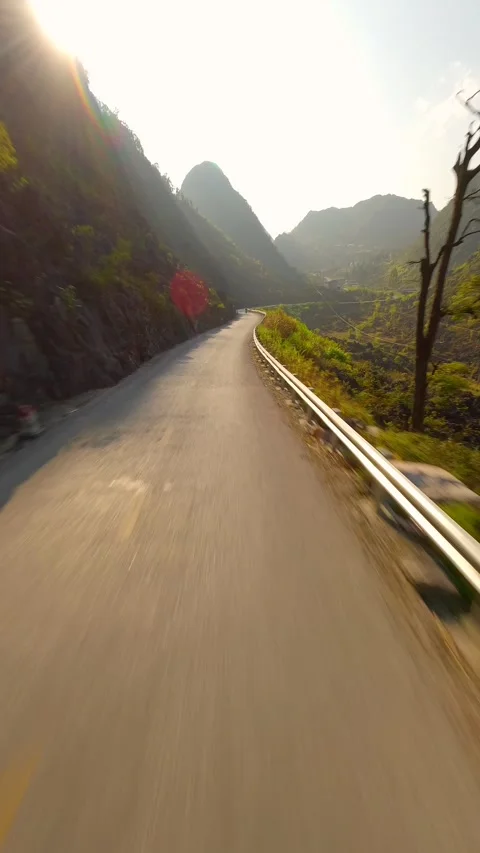 Dynamic FPV Flight Over Scenic Mountain Road on the Ha Giang Loop North Vietnam Stock Footage 283885145