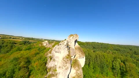Dynamic FPV flight through hole in the limestone rock of the Jurassic highlands Stock Footage 275190412