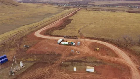 A dynamic frame in which a huge yellow caterpillar bulldozer, lit by the sun Stock Footage 168970980