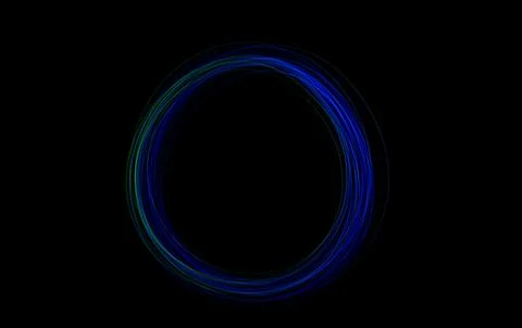 A dynamic freeze light circle glows in blue and green hues against a dark bac Stock Photos