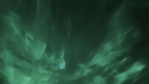 Dynamic glowing liquid light patterns shift through deep emerald green and dark  스톡 동영상 333569093