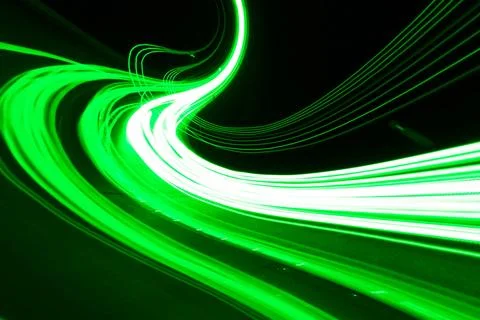 Dynamic green neon light trails with curved motion blur on black Иллюстрация