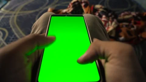 Dynamic green screen transition effect on a vertical smartphone held by a p.. Stock Footage 340490791