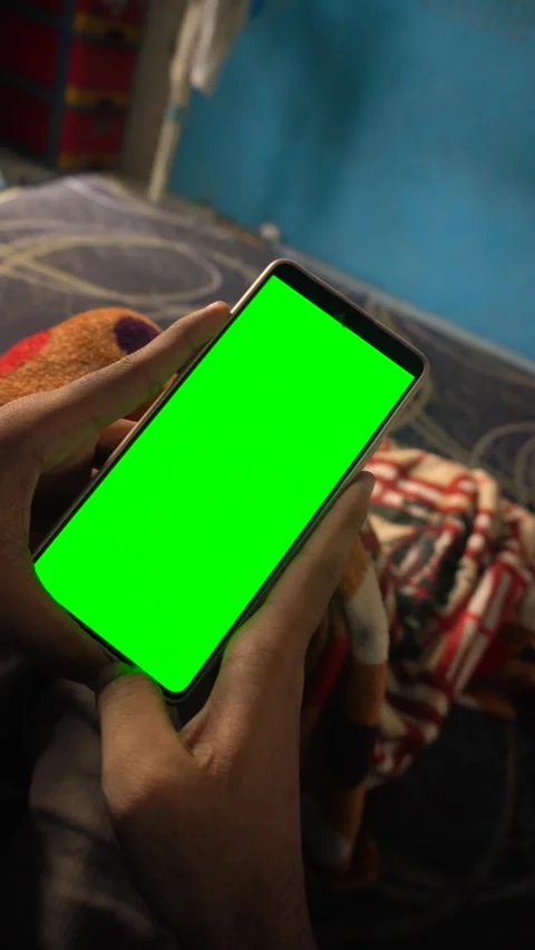 Dynamic green screen transition with a person shaking a vertical smartphone.. Stock Footage 340490914