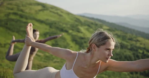 Dynamic Group Yoga Session on Mountain at Sunrise Stock Footage 278622718