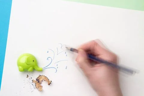 Dynamic hand drawing water splashes from the sharpener in the form of an elep Stock Photos