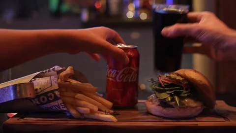 Dynamic Hands Putting Beverages into Burger Combo Stock Footage 129043884