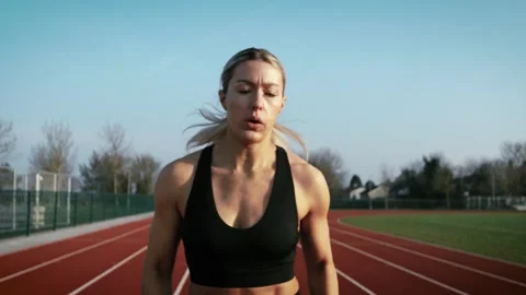Dynamic, high-speed shot of a athlete warming up on an outdoor track Stock Footage 344895712