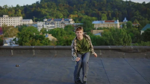 Dynamic hip-hop performance on rooftop by talented Caucasian male dancer Stock Footage 245168443