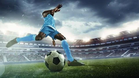 Dynamic image of man, soccer player in blue uniform preparing to kick ball on 스톡 사진