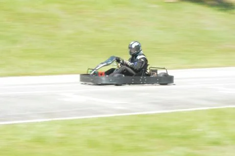 Dynamic image of pilot driving go-kart with motion blur effect Stock Photos
