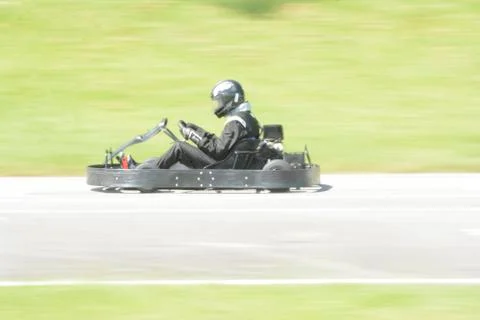 Dynamic image of pilot driving go-kart with motion blur effect Stock Photos