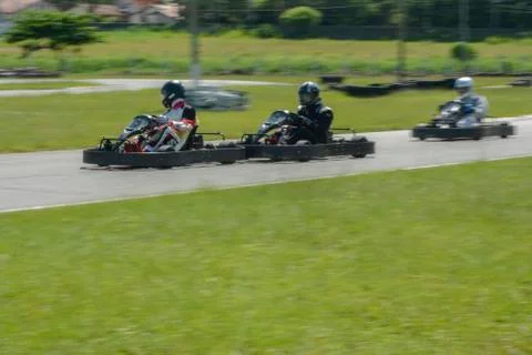 Dynamic image of three competitive, moving fast, go-karts Stock Photos