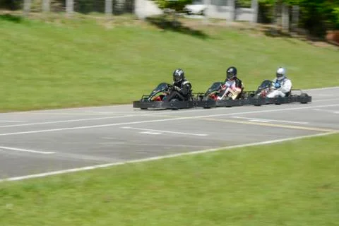 Dynamic image of three competitive, moving fast, go-karts Stock Photos