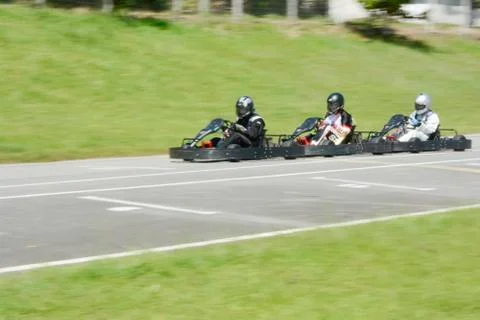 Dynamic image of three competitive, moving fast, go-karts Stock Photos