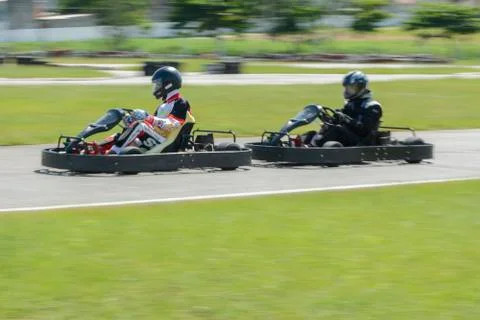 Dynamic image of two competitive, moving fast, go-karts Stock Photos