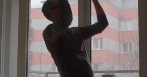 Dynamic Indoor Activity: Engaging Movements by the Window Stock Footage 316491228