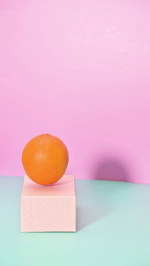 Dynamic Jumping of cheerful Orange on Pink Box. Vertical Stop Motion Video stock 277984837