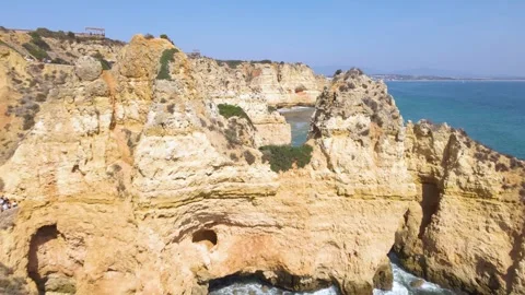 Dynamic lateral tracking aerial along Portugal's Algarve coast revealing Stock Footage 330924126