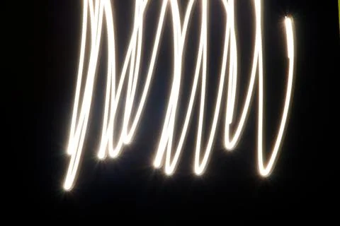 Dynamic light trails dancing across a dark canvas Foto stock