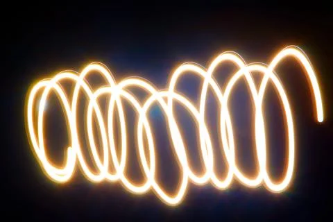 Dynamic light trails dancing across a dark canvas Stock Photos