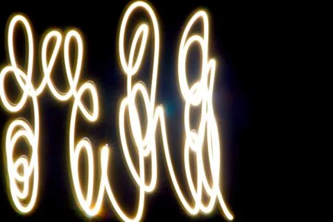 Dynamic light trails dancing across a dark canvas Foto stock