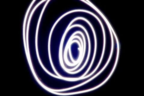 Dynamic light trails dancing across a dark canvas Stock Photos