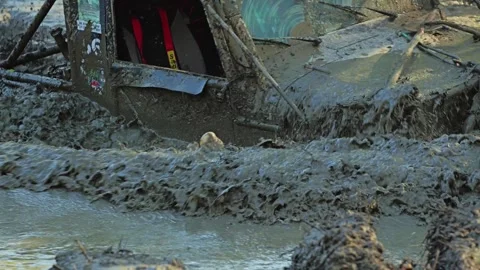 Dynamic low-angle action shot of an off-road vehicle racing through a puddle Stock Footage 345495569