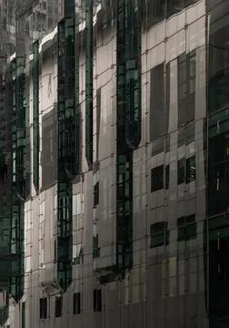 A dynamic low-angle perspective, the contemporary curtain wall reveals a rh.. Stock Photos