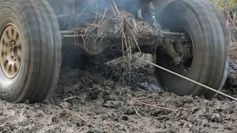 Dynamic low-angle shot of a powerful off-road UTV stuck in mud Vídeo Stock 344876624