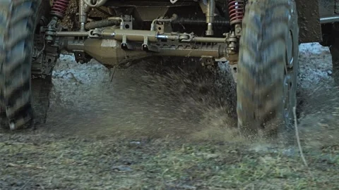 A dynamic low-angle shot of a UTV's spinning wheels and suspension Vídeo Stock 344876661
