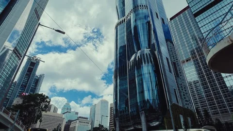 A dynamic low-angle view of a bustling Hong Kong cityscape in slow motion. Stock Footage 338311562