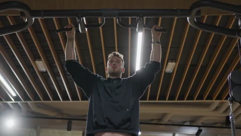 Dynamic Low Angle View of Man Performing Pull Ups Stock Footage 346485204