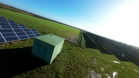 Dynamic low-pass FPV flight rushing past clean energy infrastructure arrays Stock-Footage 340897892